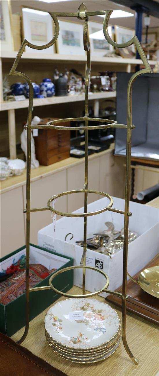 A three tier metal cake stand, six dessert dishes and a floral encrusted fruit bowl